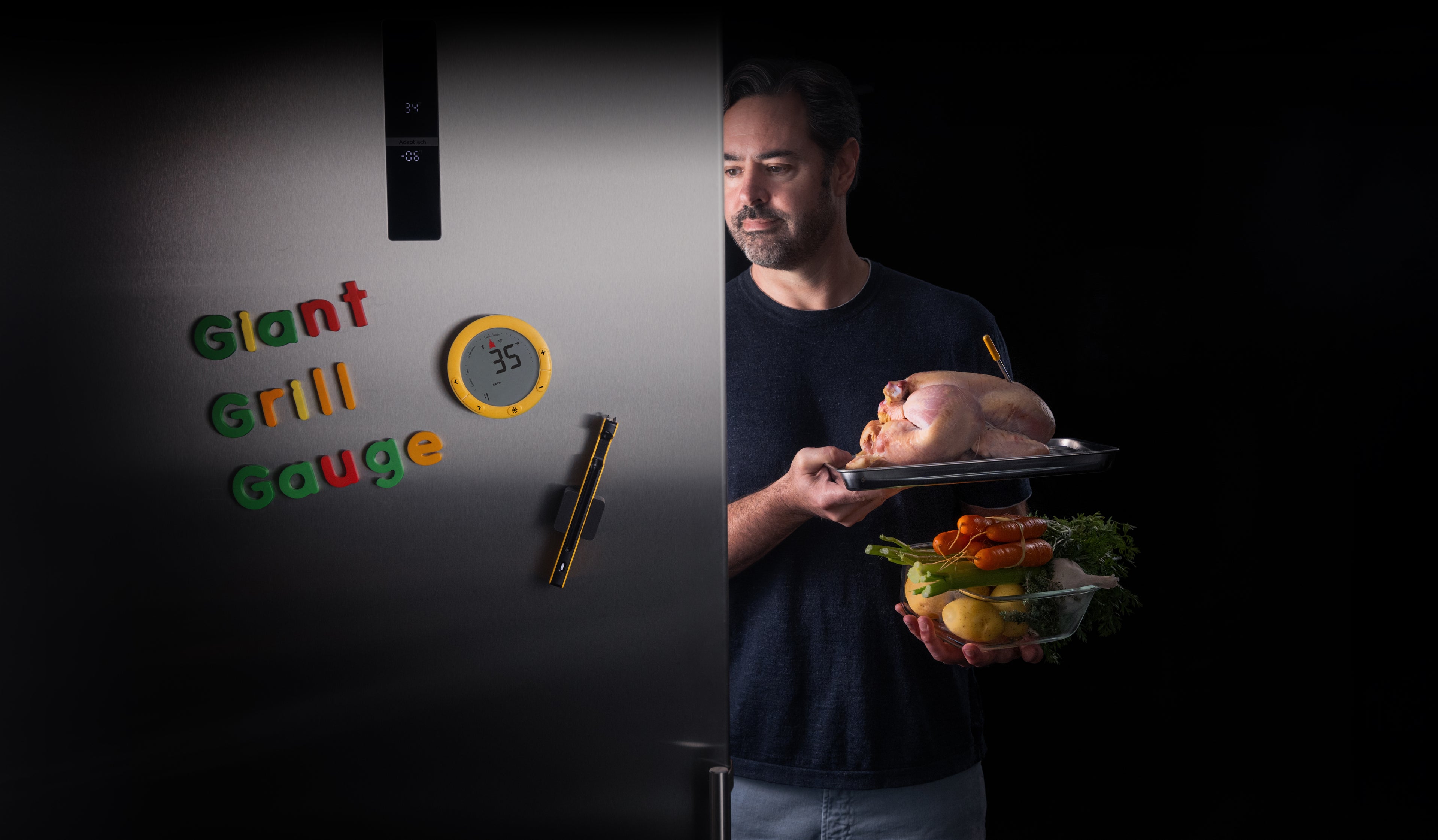 Giant Grill Gauge, magnetized to fridge, displaying temp from nearby turkey - Chris Young holds turkey with Predictive Thermoemter